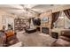 Comfortable living room features a stone fireplace, built-in shelving, and plush furniture at 13331 W Romain Ct, Litchfield Park, AZ 85340