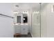 Bright bathroom featuring double sinks, wood-look floors, and a glass-enclosed shower at 14175 W Bronco Trl, Surprise, AZ 85387
