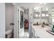 Bathroom featuring a modern vanity and mirror, a walk-in closet, and an adjacent toilet at 14175 W Bronco Trl, Surprise, AZ 85387