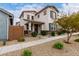Inviting two-story home featuring gray shutters, a front porch, and a meticulously xeriscaped front yard at 14175 W Bronco Trl, Surprise, AZ 85387