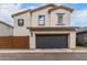 Charming two-story home with a stucco exterior and a two-car garage at 14175 W Bronco Trl, Surprise, AZ 85387