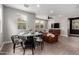 Open-concept layout connecting living and dining areas, featuring wood-look flooring and modern furnishings at 14175 W Bronco Trl, Surprise, AZ 85387