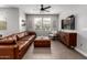 Comfortable living room featuring stylish furniture, a ceiling fan, and plenty of natural light at 14175 W Bronco Trl, Surprise, AZ 85387