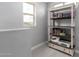 Bright loft space featuring neutral walls, a window, and a bookshelf with a sewing machine and printer at 14175 W Bronco Trl, Surprise, AZ 85387