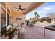 Comfortable back patio with ceiling fan, seating, and desert landscaping at 14218 W Via Montoya --, Sun City West, AZ 85375