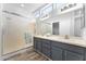 Bright bathroom features dual sinks, large mirror, white countertops, and tiled shower at 14218 W Via Montoya --, Sun City West, AZ 85375