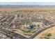 Wide aerial view showcasing the community clubhouse, pool, tennis courts, and parking at 14218 W Via Montoya --, Sun City West, AZ 85375
