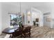 Elegant dining area with a wooden table, chandelier lighting, and a bright window view at 14218 W Via Montoya --, Sun City West, AZ 85375