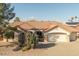 Charming single-story home with a terracotta tile roof, desert landscaping, and an attached two-car garage at 14218 W Via Montoya --, Sun City West, AZ 85375