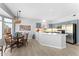 Bright kitchen and dining area with updated appliances, cabinetry, and a stylish chandelier over the dining table at 14218 W Via Montoya --, Sun City West, AZ 85375