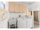Well-lit laundry room with modern washer, dryer, and sink at 14218 W Via Montoya --, Sun City West, AZ 85375