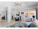 Bright living room featuring neutral tones, a ceiling fan, access to the patio, and a cozy seating area at 14218 W Via Montoya --, Sun City West, AZ 85375