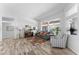 Bright living room with neutral decor, wood-look flooring, and large windows providing ample natural light at 14218 W Via Montoya --, Sun City West, AZ 85375