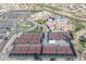 Aerial view of the community tennis courts with well-maintained grounds and close proximity to the clubhouse and parking at 14218 W Via Montoya --, Sun City West, AZ 85375