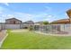 Spacious backyard featuring artificial turf, a pool with a fence, and a patio with furniture at 14875 W Larkspur Dr, Surprise, AZ 85379