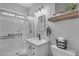 Bright bathroom features a glass-enclosed shower, modern vanity, and stylish decor on the floating shelf at 14875 W Larkspur Dr, Surprise, AZ 85379