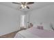 Bright bedroom features a single bed with window, closet, and a light pink bedside table adding a cozy and stylish touch at 14875 W Larkspur Dr, Surprise, AZ 85379