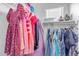 Well-organized closet boasts a variety of clothes, providing storage and a glimpse into the home's functional design at 14875 W Larkspur Dr, Surprise, AZ 85379