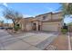 Inviting two-story home featuring a spacious driveway and attached two-car garage at 14875 W Larkspur Dr, Surprise, AZ 85379
