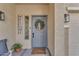 Cozy front porch featuring a seating area, wreath, and doormat at 14875 W Larkspur Dr, Surprise, AZ 85379