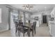 This charming open-concept kitchen features stainless appliances, white cabinets, and adjacent dining area at 14875 W Larkspur Dr, Surprise, AZ 85379