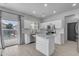 Charming kitchen with white cabinets and stainless steel appliances, opens to an outdoor pool area at 14875 W Larkspur Dr, Surprise, AZ 85379