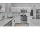 This kitchen features white cabinets and stainless steel appliances, including a built-in microwave at 14875 W Larkspur Dr, Surprise, AZ 85379
