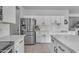 Bright kitchen with white cabinets, stainless steel appliances, and quartz countertops at 14875 W Larkspur Dr, Surprise, AZ 85379