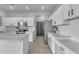 Bright kitchen with white cabinets, stainless steel appliances, quartz countertops, and subway tile backsplash at 14875 W Larkspur Dr, Surprise, AZ 85379