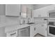 Bright kitchen offers ample counter space, stainless steel appliances and white subway tile backsplash at 14875 W Larkspur Dr, Surprise, AZ 85379