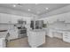 Bright kitchen features stainless steel appliances, white cabinets and a stylish center island at 14875 W Larkspur Dr, Surprise, AZ 85379