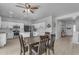 Open-concept kitchen with a dining area featuring stainless appliances and bright white cabinets at 14875 W Larkspur Dr, Surprise, AZ 85379