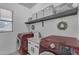 Laundry room with red washer and dryer and storage shelves at 14875 W Larkspur Dr, Surprise, AZ 85379