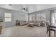 Light and airy living room featuring tile floors and two sofas at 14875 W Larkspur Dr, Surprise, AZ 85379