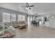Open concept living and dining area with tile floors and plenty of natural light at 14875 W Larkspur Dr, Surprise, AZ 85379