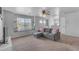 Bright living room features a window seat, comfortable sectional sofa, and natural light at 14875 W Larkspur Dr, Surprise, AZ 85379