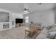 Spacious living room features modern decor, wood-look tile flooring, and a cozy atmosphere at 14875 W Larkspur Dr, Surprise, AZ 85379