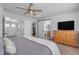 Bright main bedroom boasts a ceiling fan, ensuite bathroom with sliding barn door, and walk in closet for ample storage at 14875 W Larkspur Dr, Surprise, AZ 85379