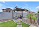 Backyard pergola with comfortable seating, fire pit, and landscaping at 14875 W Larkspur Dr, Surprise, AZ 85379