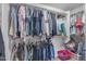 Well-organized walk-in closet with shelving and hanging rods providing efficient storage solutions for clothing and accessories at 14875 W Larkspur Dr, Surprise, AZ 85379