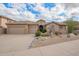 Charming single-story home featuring a three-car garage and desert landscaping at 15015 E Vermillion Dr, Fountain Hills, AZ 85268