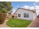 Well-maintained backyard with lush green grass, mature trees, and a covered patio area at 1502 E Detroit St, Chandler, AZ 85225