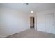 Bedroom featuring decorative wall molding, neutral carpet, a ceiling fan, and closet space at 1502 E Detroit St, Chandler, AZ 85225