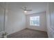 Bedroom with decorative wall molding, neutral carpet, a ceiling fan, and a bright window at 1502 E Detroit St, Chandler, AZ 85225