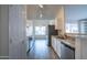 Well-lit kitchen features white cabinets, stainless steel appliances, and a view to the backyard at 1502 E Detroit St, Chandler, AZ 85225