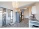 Bright, open kitchen with stainless steel refrigerator and modern chandelier, ideal for Gathering gatherings at 1502 E Detroit St, Chandler, AZ 85225