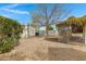 Gravel backyard featuring a mature shade tree, small garden, and block wall fencing at 16215 N 35Th Pl, Phoenix, AZ 85032