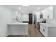 Bright, open kitchen with white cabinets, quartz countertops, and stainless steel appliances at 16215 N 35Th Pl, Phoenix, AZ 85032