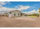 Expansive backyard featuring a gravel area, small shed, and a grassy section with palm trees, perfect for outdoor activities at 17017 N Palo Azul Rd, Maricopa, AZ 85138