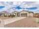 Exterior of a desert home with a two-car garage and low-maintenance landscaping at 17017 N Palo Azul Rd, Maricopa, AZ 85138